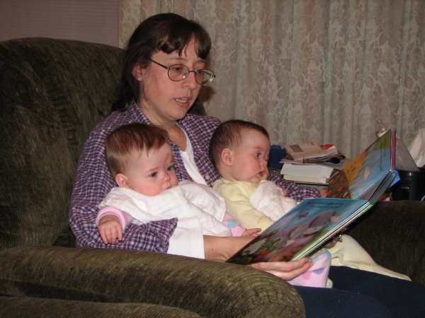 Janet reads a bedtime story to Elizabeth & Carolyn